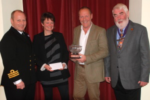 Jayne and Joe Murtagh of the Canvas Factory  won theClause Seeds Rose Bowl for Best Overall Display, Commercial. They are pictured with Commader Jason Phillips BRNC and Mayor Elect Rob Lyon