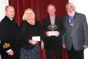 Martin and Angela Cairns-Sharp of Valley House  a won the Dartmouth in Bloom Shield for Best Bed & Breakfast. They are pictured with Commander Jason Phillips BRNC and Mayor Elect Rob Lyon